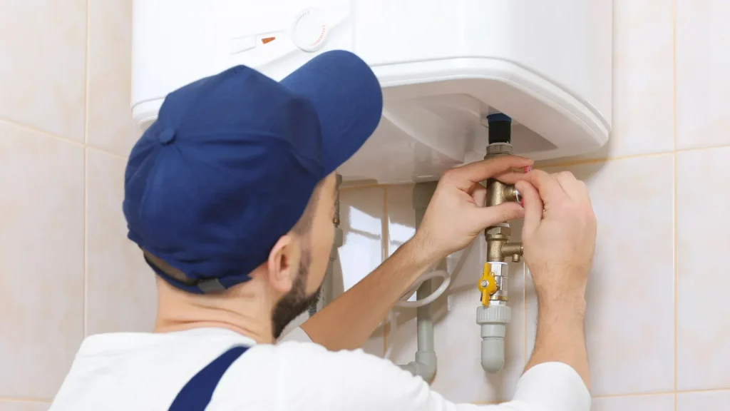 Plumber repairing a water heater with heating problems