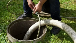 echnician opening and inspecting a home's septic tank